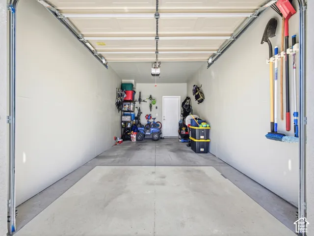 Spacious garage with light-toned walls and a durable concrete floor