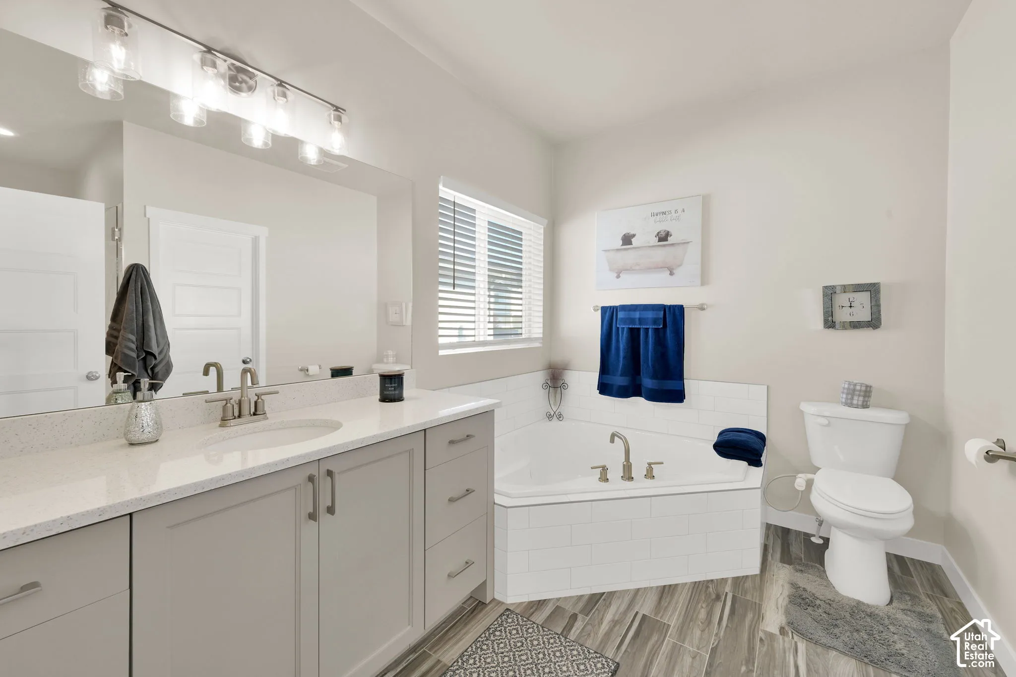 Quartz countertops, large tub and LVP flooring