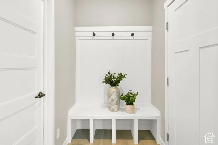 Built-in bench with cubby storage, beadboard paneling, and integrated coat hooks
