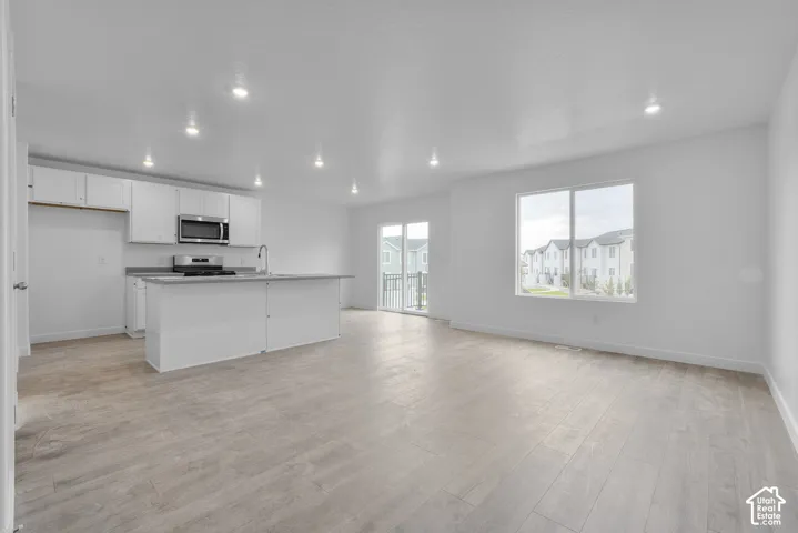 Open concept living area featuring wood-finish flooring
