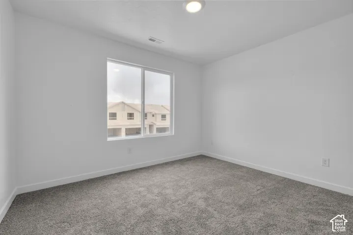 Neutral-toned walls complement the gray carpeting