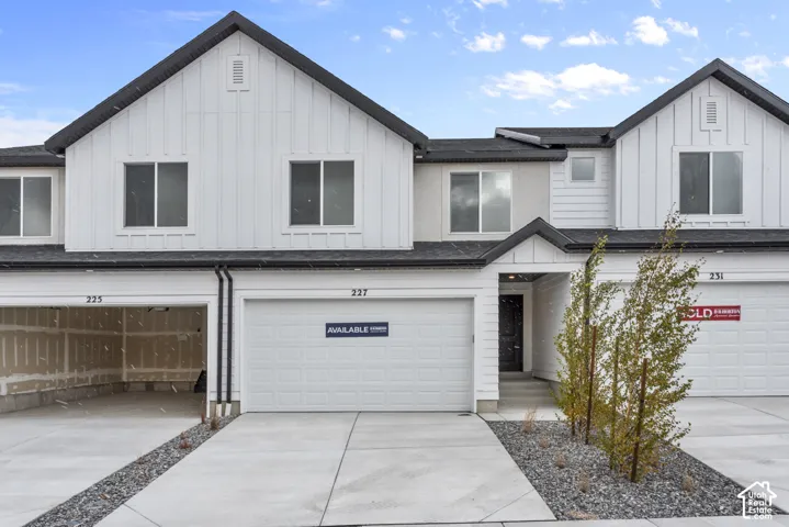 Modern exterior with white vertical siding and dark trim