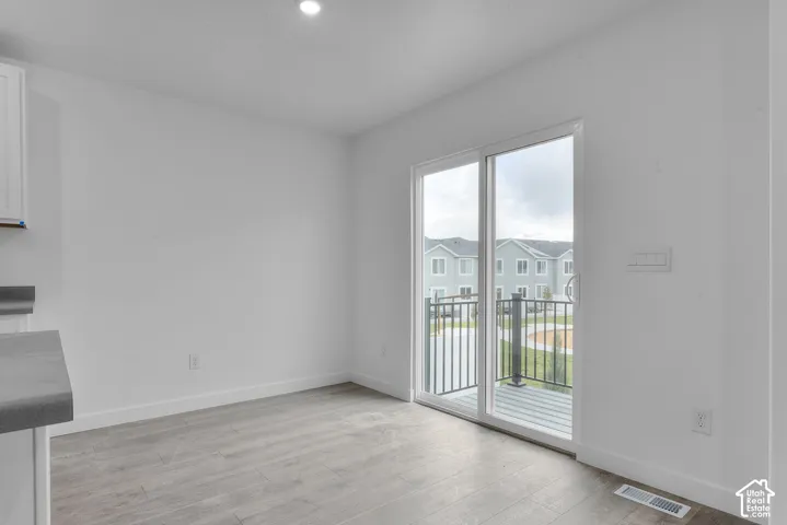 Sliding glass door opening to a private balcony with black metal railings