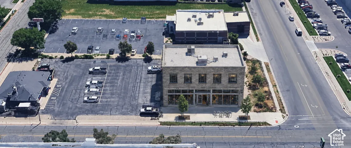 Commercial property featuring a brick exterior, multiple windows, and a flat roof...AI generated rendering of what could be built.