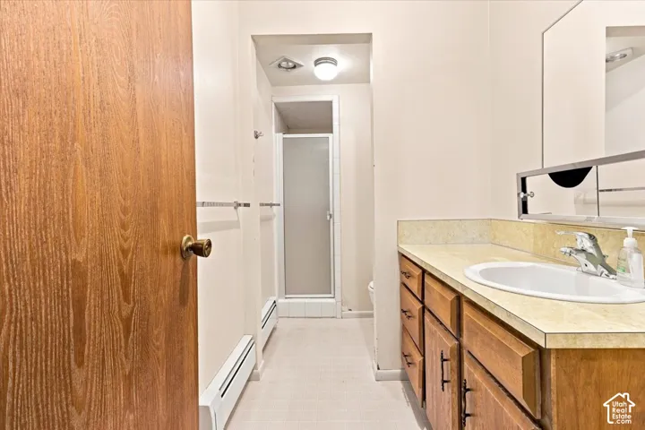 Vanity with an integrated sink, wood-finish cabinetry, and a surface-mounted medicine cabinet