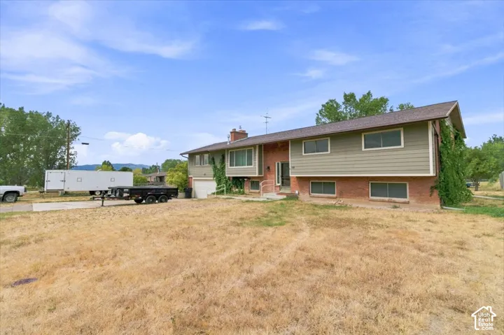 Brick and siding exterior with a multi-level design and an attached garage