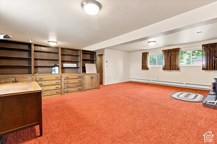 Spacious room featuring extensive built-in wooden shelving and cabinetry, multiple windows, and recessed lighting fixtures