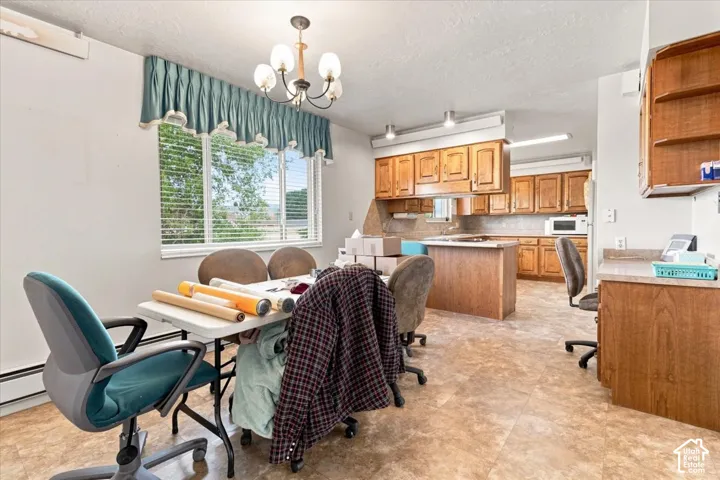 Kitchen with wood-finish cabinetry, a central island, and an integrated microwave