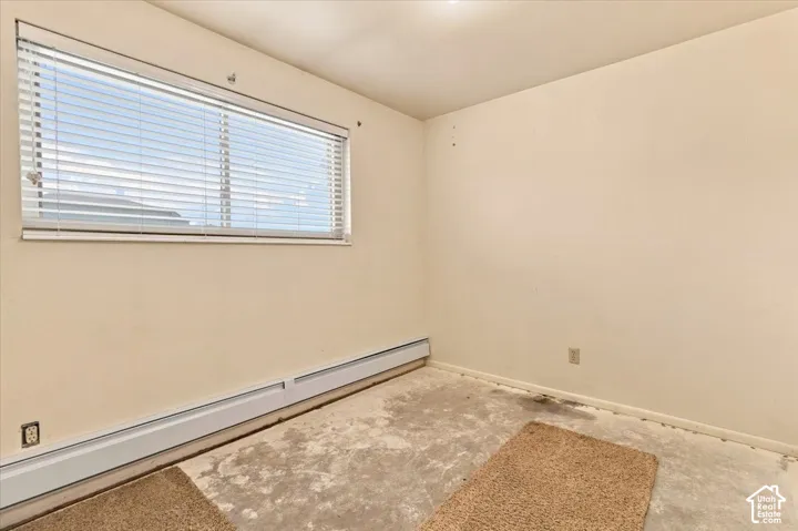 Window with horizontal blinds and baseboard heating unit