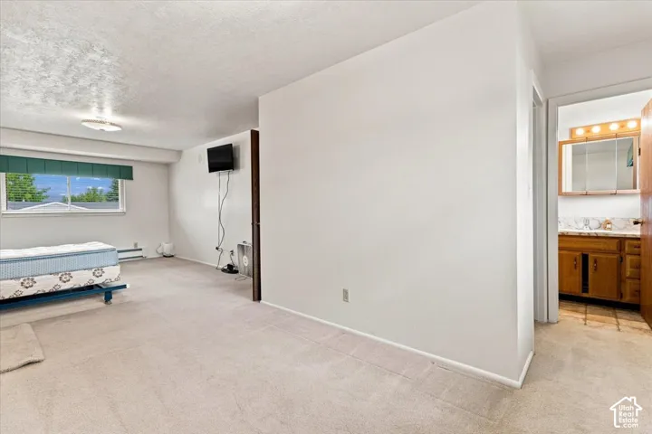 Spacious room with light-toned carpeting and a wide window