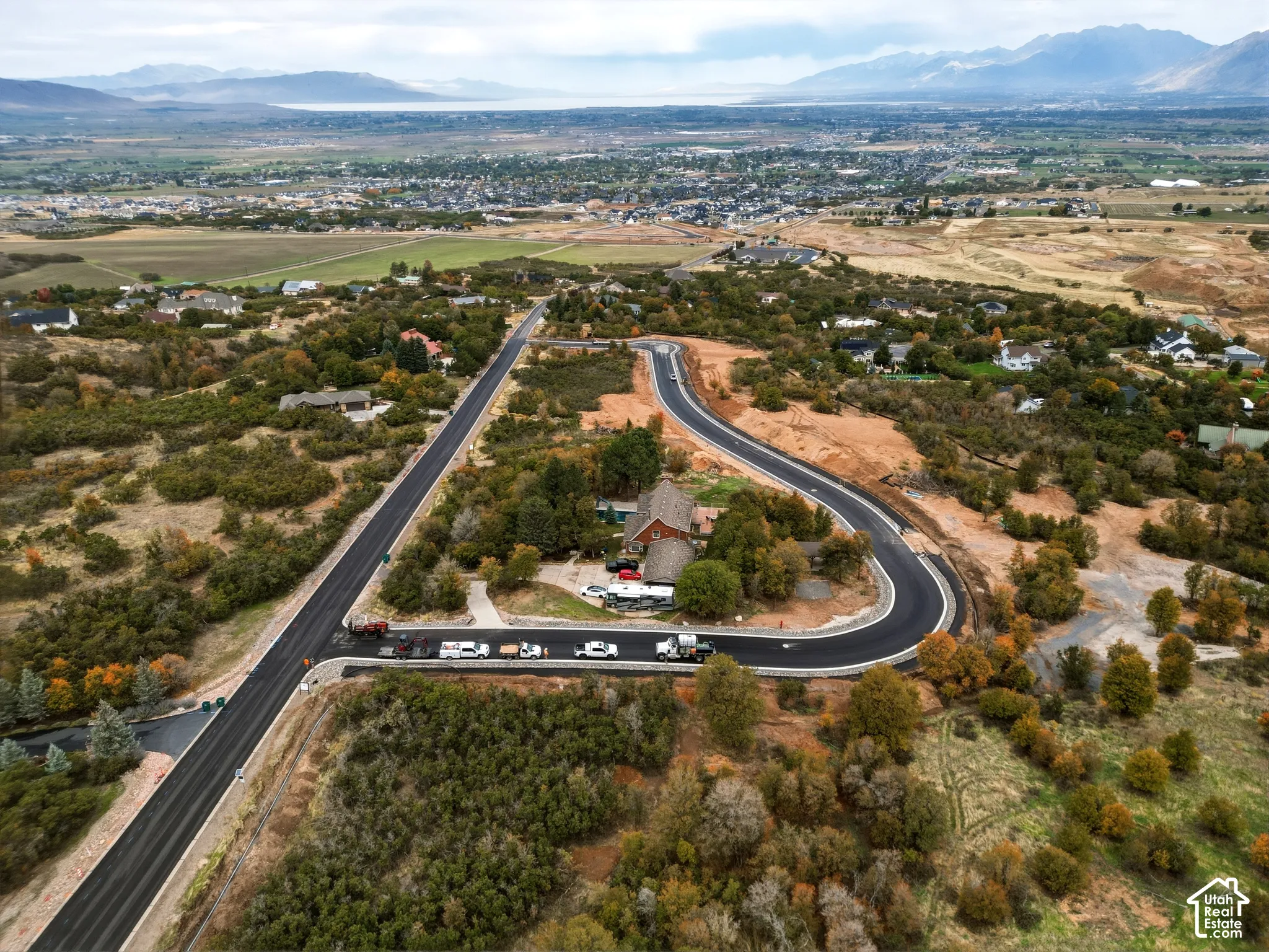 Developing residential area with paved roads and surrounding natural landscape