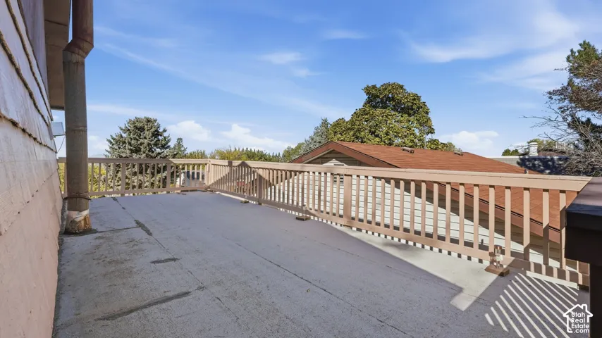 Expansive elevated deck featuring solid surface flooring and vertical balustrade railing