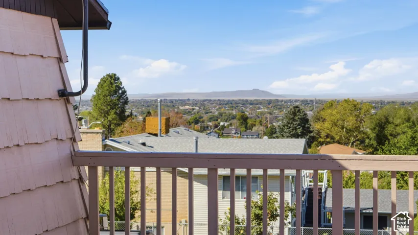 Elevated wood-railing balcony featuring mountain and landscape scenery