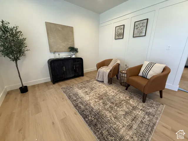 Light wood-finish flooring with white wall trim
