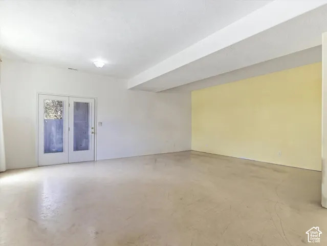 Spacious interior with polished concrete flooring, recessed ceiling lighting, and clean white walls