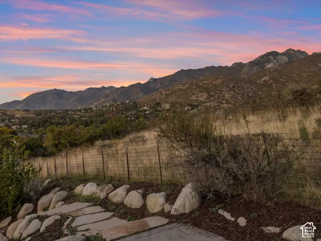 Mountain range backdrop, natural landscaping, rock border, stepping stone pathway, wire fencing