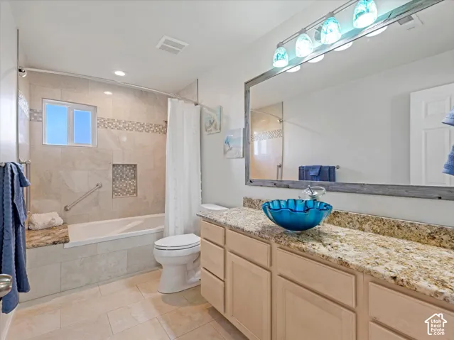 Vanity with a granite countertop and wood-finish cabinetry