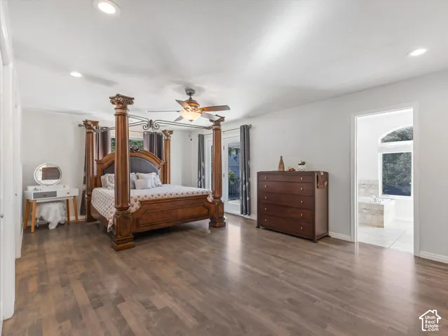 Recessed ceiling lights, wood-finish flooring, ceiling fan with light fixture, double French doors, and an arched window