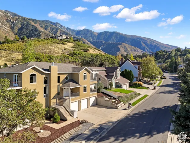 Striking contemporary home situated on a sloped lot with mountain backdrop