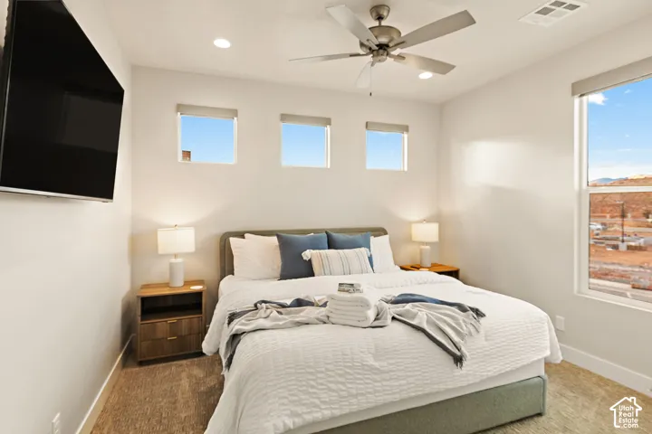 Recessed lighting, ceiling fan, wall-mounted television, and multiple windows