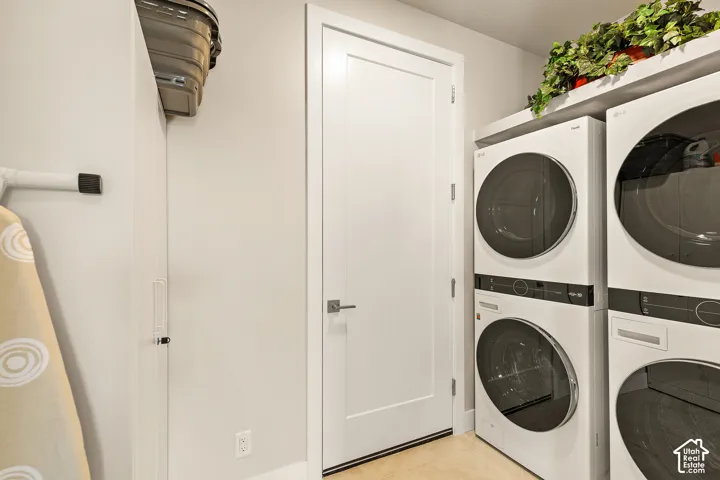 White flat-panel door, light-colored walls, and stacked front-loading laundry machines