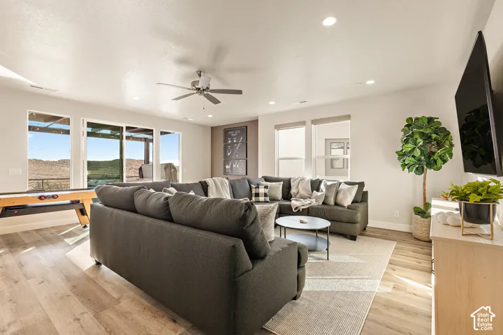 Recessed lighting, wood-finish flooring, ceiling fan, and extensive windows with exterior access