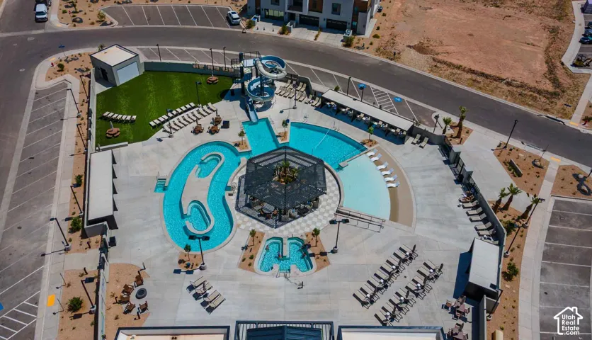 Expansive aquatic area featuring a winding river pool, water slide, and a separate wading pool