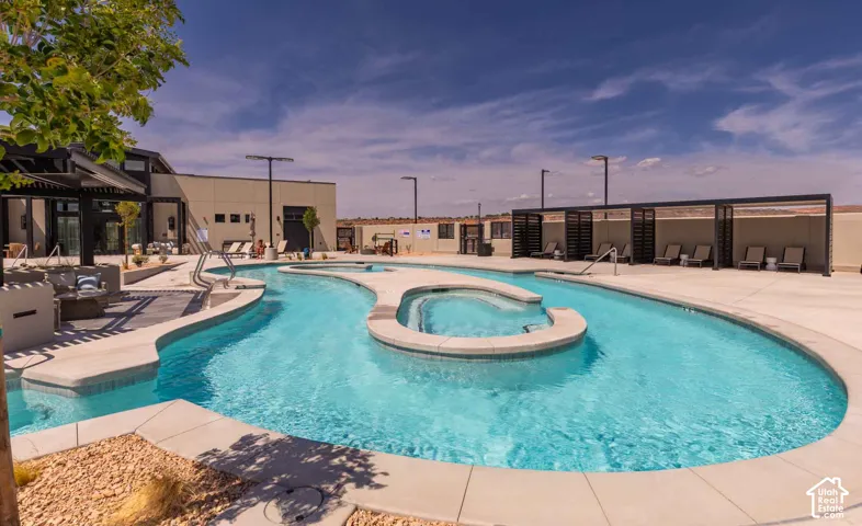 Resort-style pool with integrated spa and surrounding hardscaping