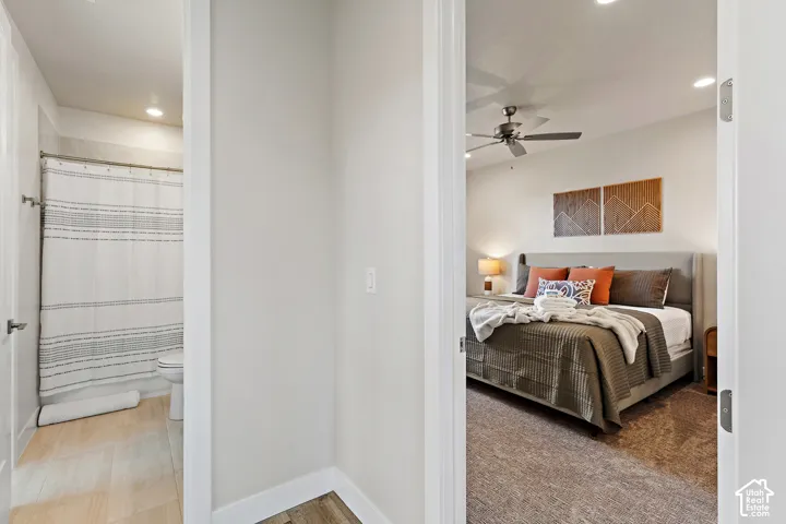 Bedroom featuring a ceiling fan with integrated lighting, recessed lighting, and a soft-hued wall finish