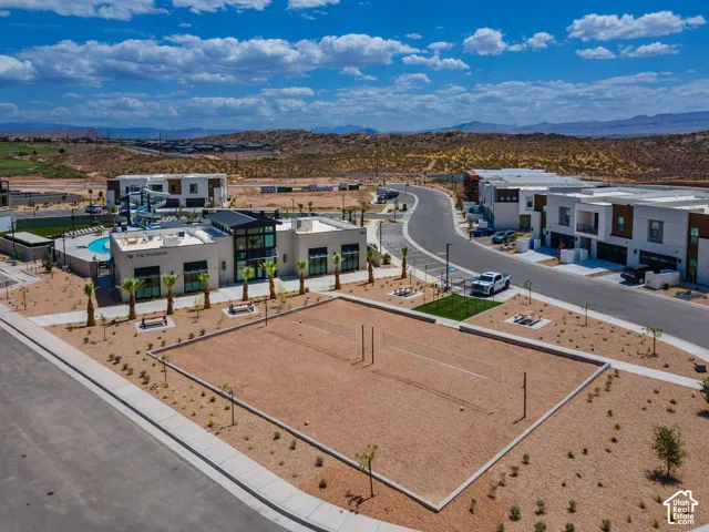 Community amenities featuring a sand volleyball court, resort-style pool with waterslides, and contemporary clubhouse