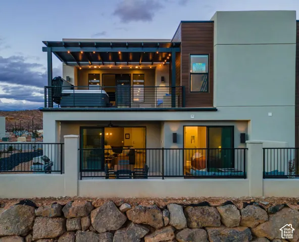Multi-level exterior with a stone retaining wall and a built-in pergola