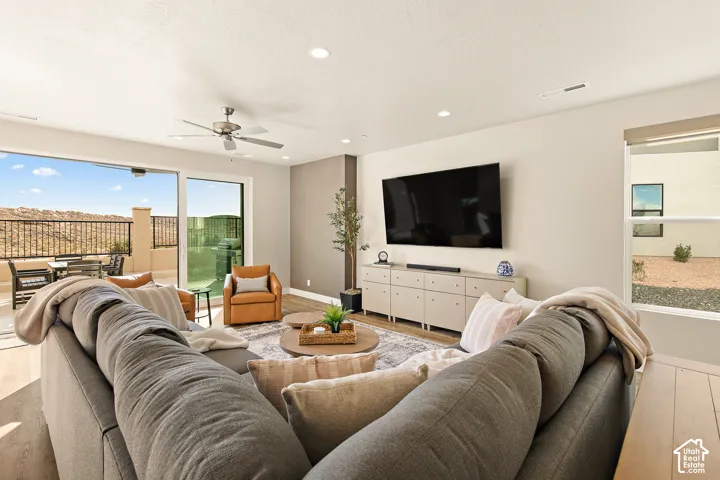 Spacious living area featuring wood-finish flooring, recessed lighting, and a ceiling fan