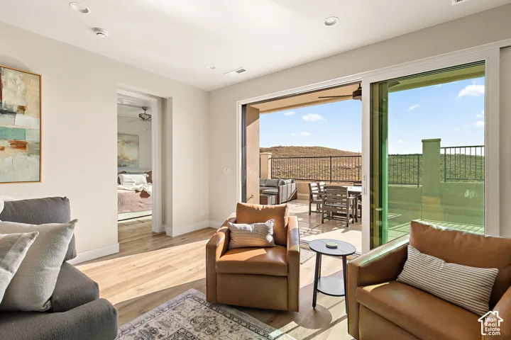 Sliding glass door opening to an outdoor patio with a mountain backdrop