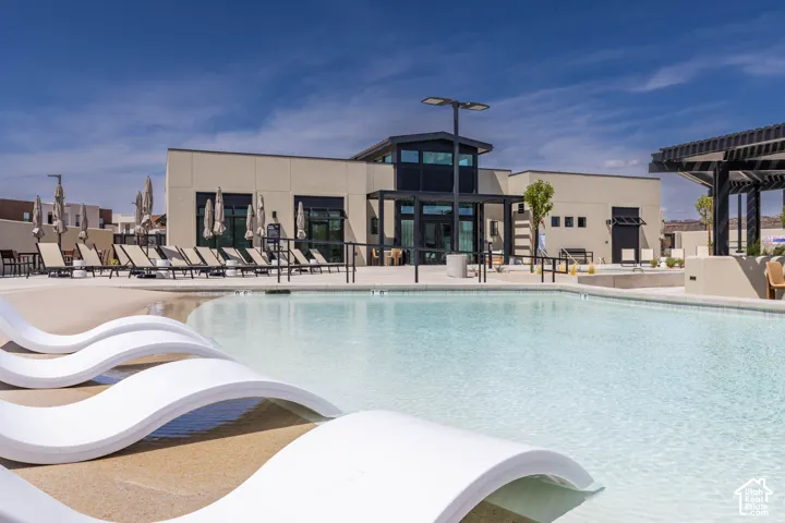 Expansive swimming pool with integrated sun lounging areas and a surrounding paved deck