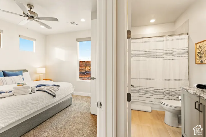 Bedroom featuring a ceiling fan, recessed lighting, and two windows