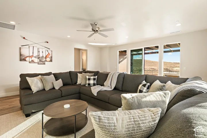 Recessed lighting, ceiling fan, wood-finish flooring, and large sliding glass doors