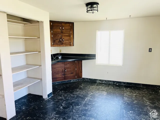 Large pantry and dining area with desk and cabinets