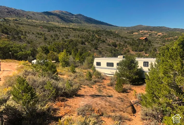 SWEEPING VIEWS looking West over TOP Lot flatter terrain area.  (Trailers & wood/shed materials are negotiable)