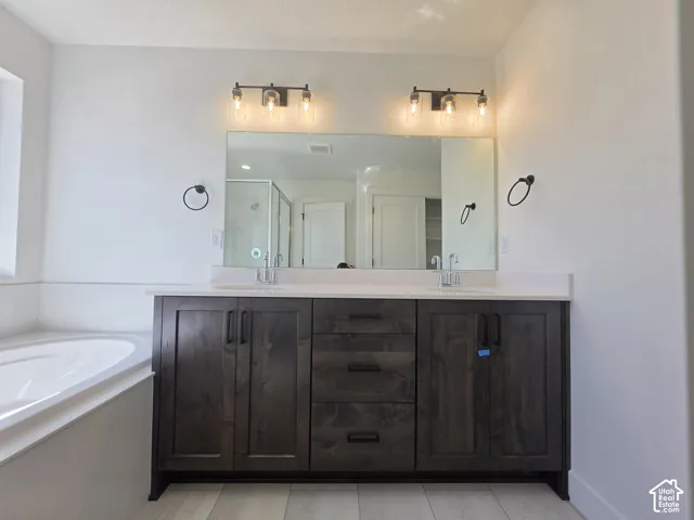 Dual vanity with wood-finish cabinetry, white countertop, and rectangular undermount sinks