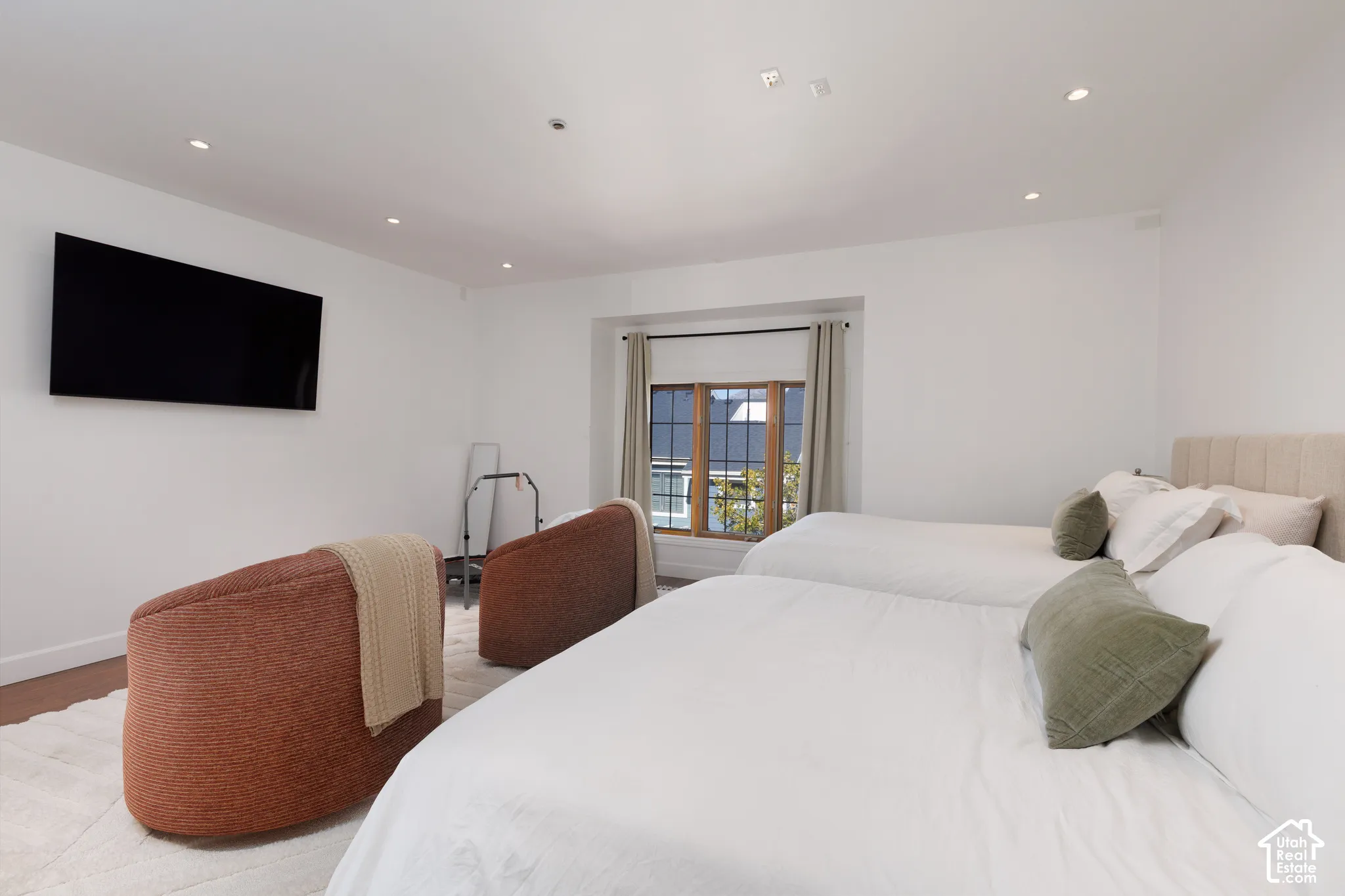 Recessed ceiling lighting, wood-frame window, and wood-finish flooring
