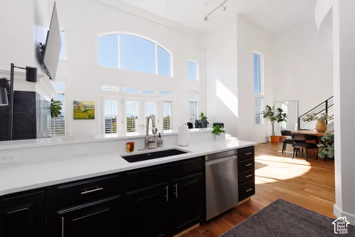 Modern kitchen featuring white countertops, dark cabinetry, and stainless steel appliances