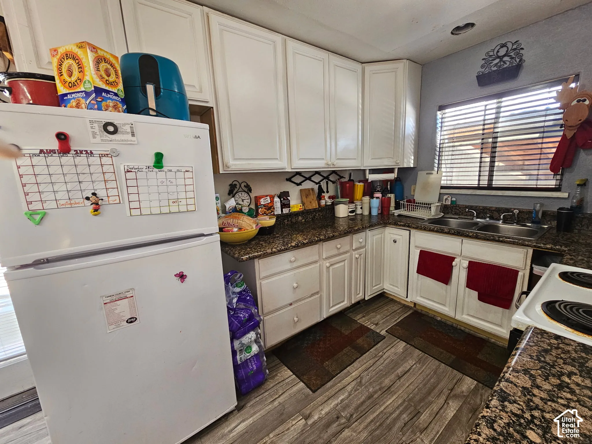 White cabinetry paired with granite-finish countertops
