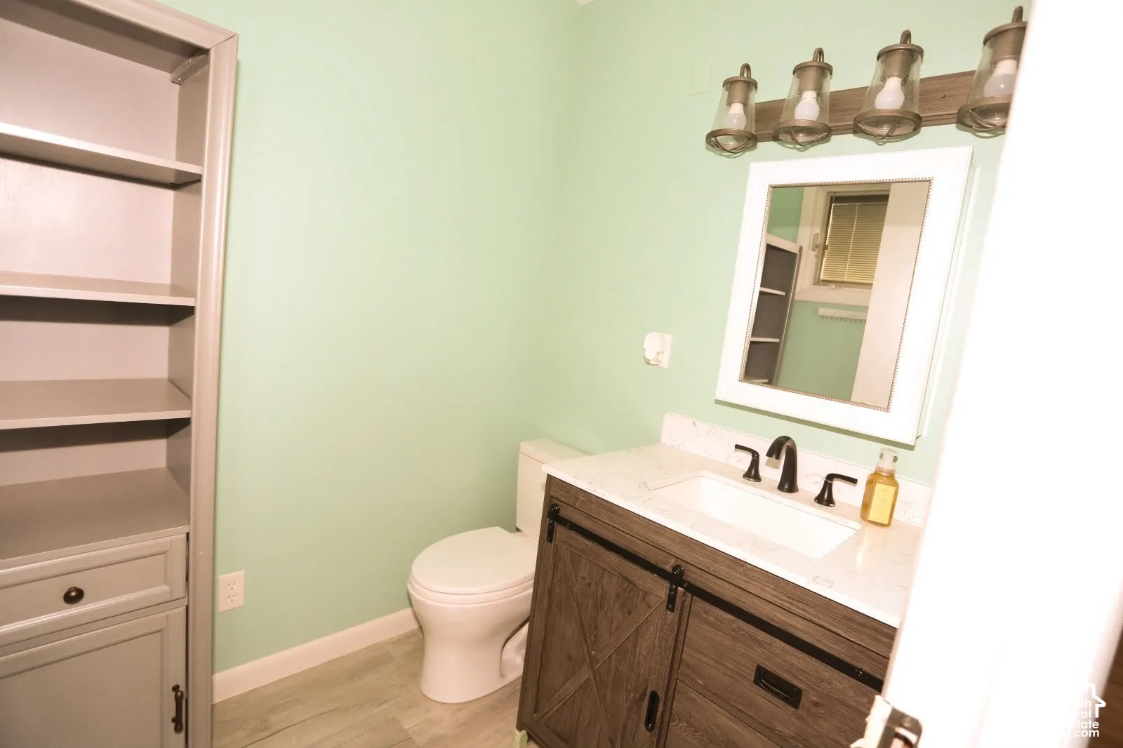 Wood-finish vanity with a white countertop and rectangular undermount sink