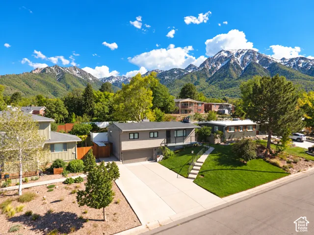 Contemporary-style residence with a two-car garage, concrete driveway, and landscaped front yard