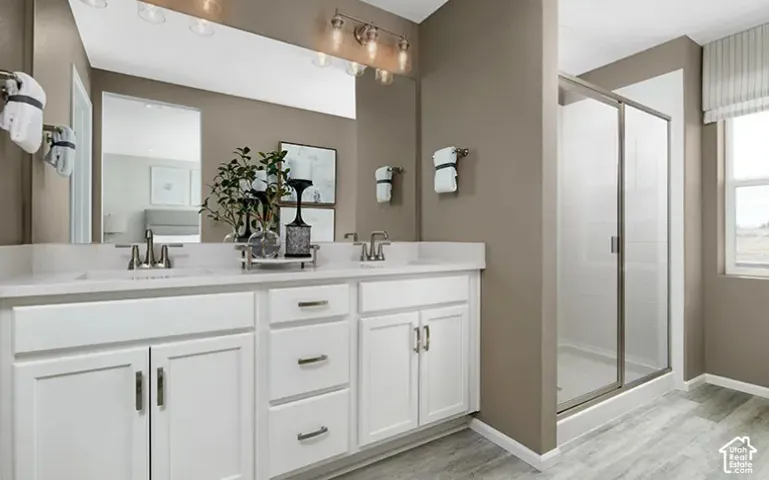 Dual vanity with white cabinetry, integrated sinks, and brushed nickel hardware