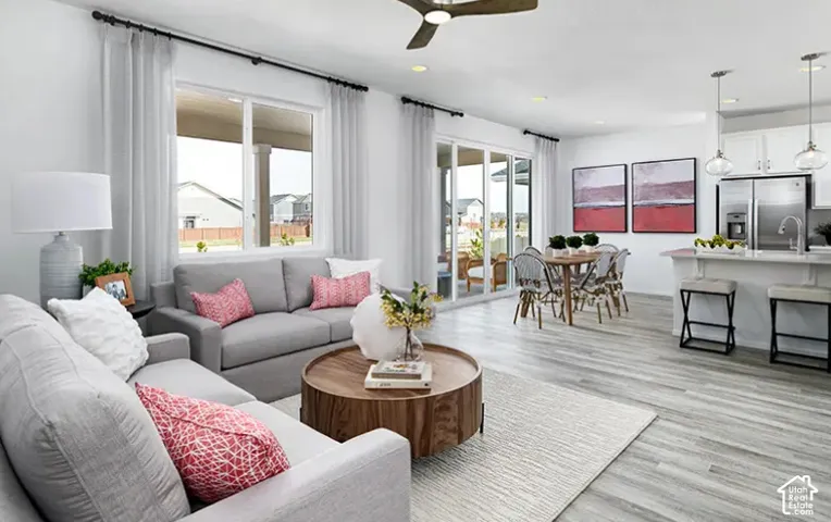Open concept living area with wood-finish flooring