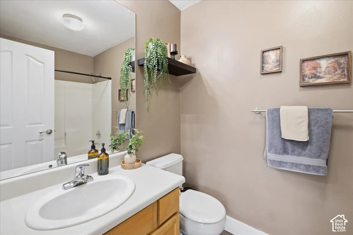 Bathroom featuring a vanity with an integrated sink and chrome faucet