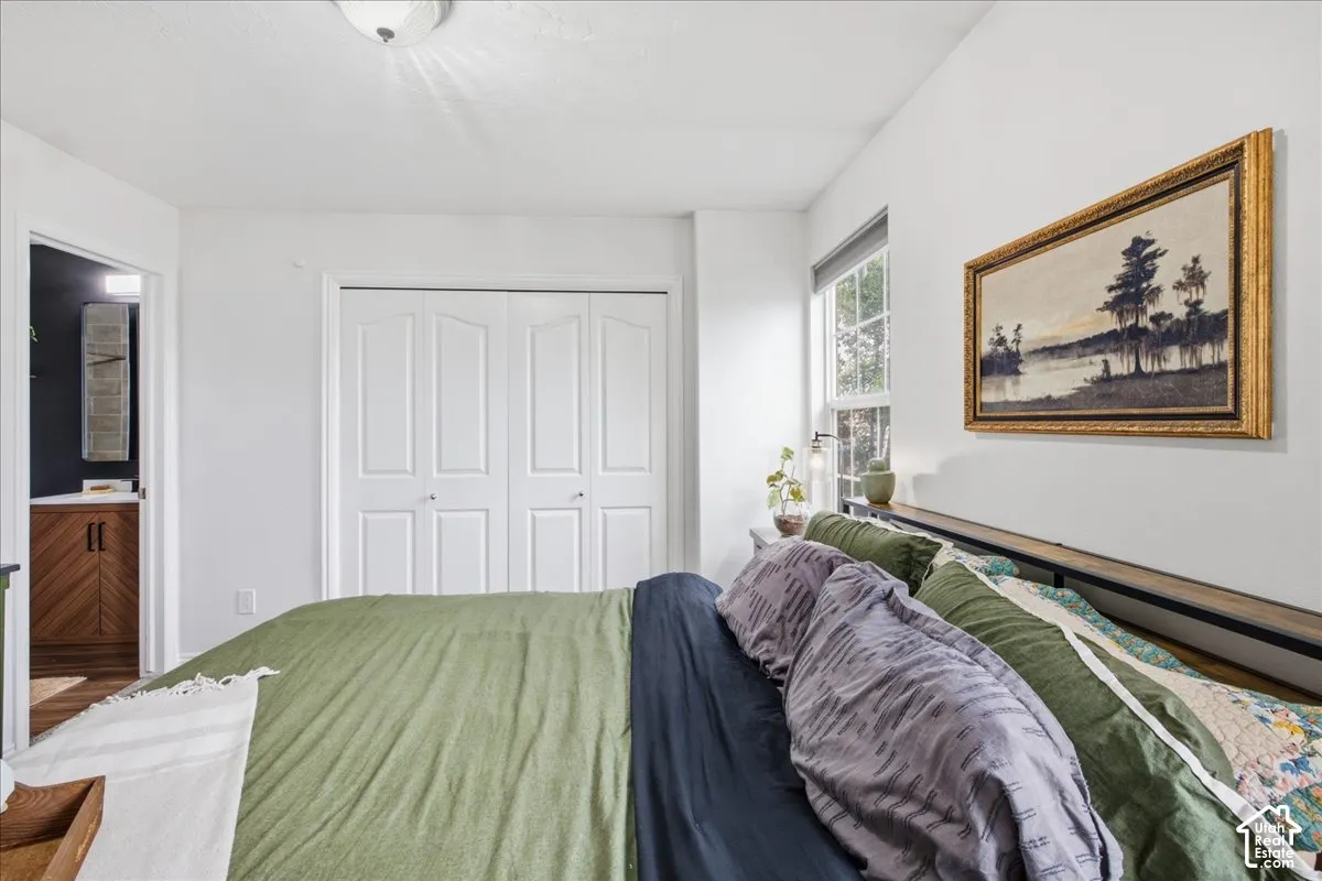 White walls, recessed window, and a built-in closet with bi-fold doors