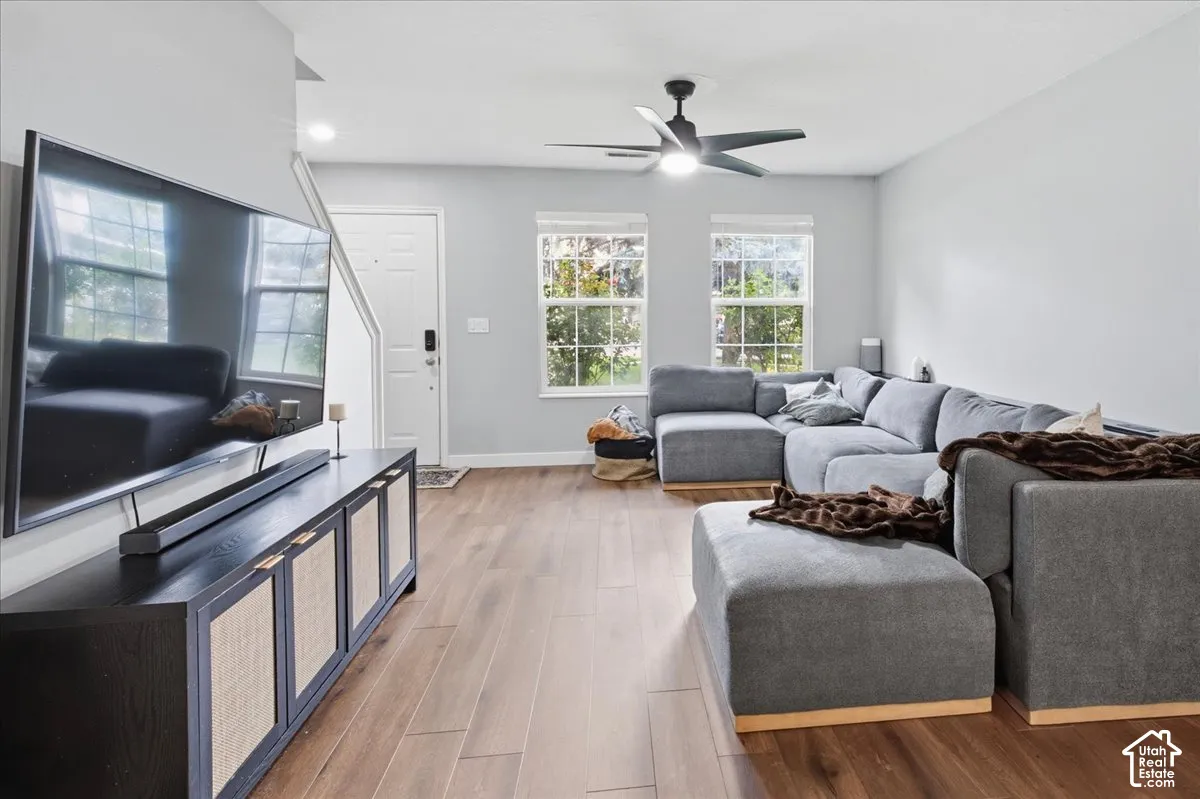 Hardwood-finish flooring throughout, recessed lighting, and dual windows provide ample illumination