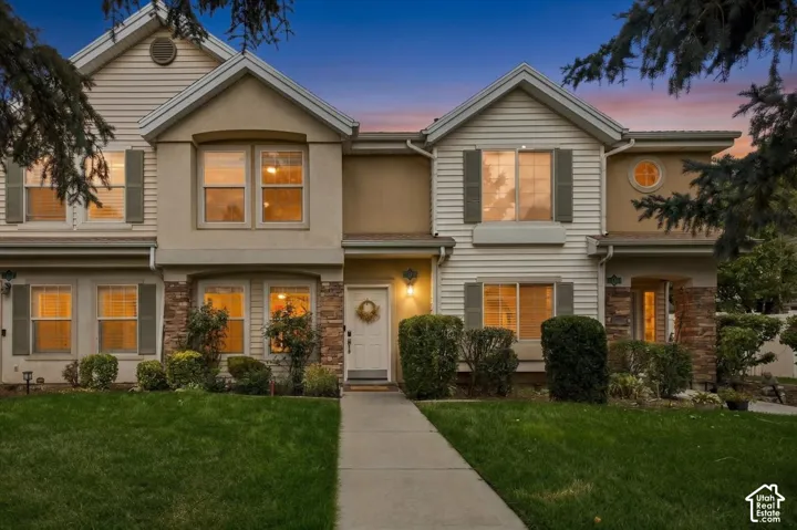 Siding exterior with stone accents, multiple windows, and a prominent front entrance